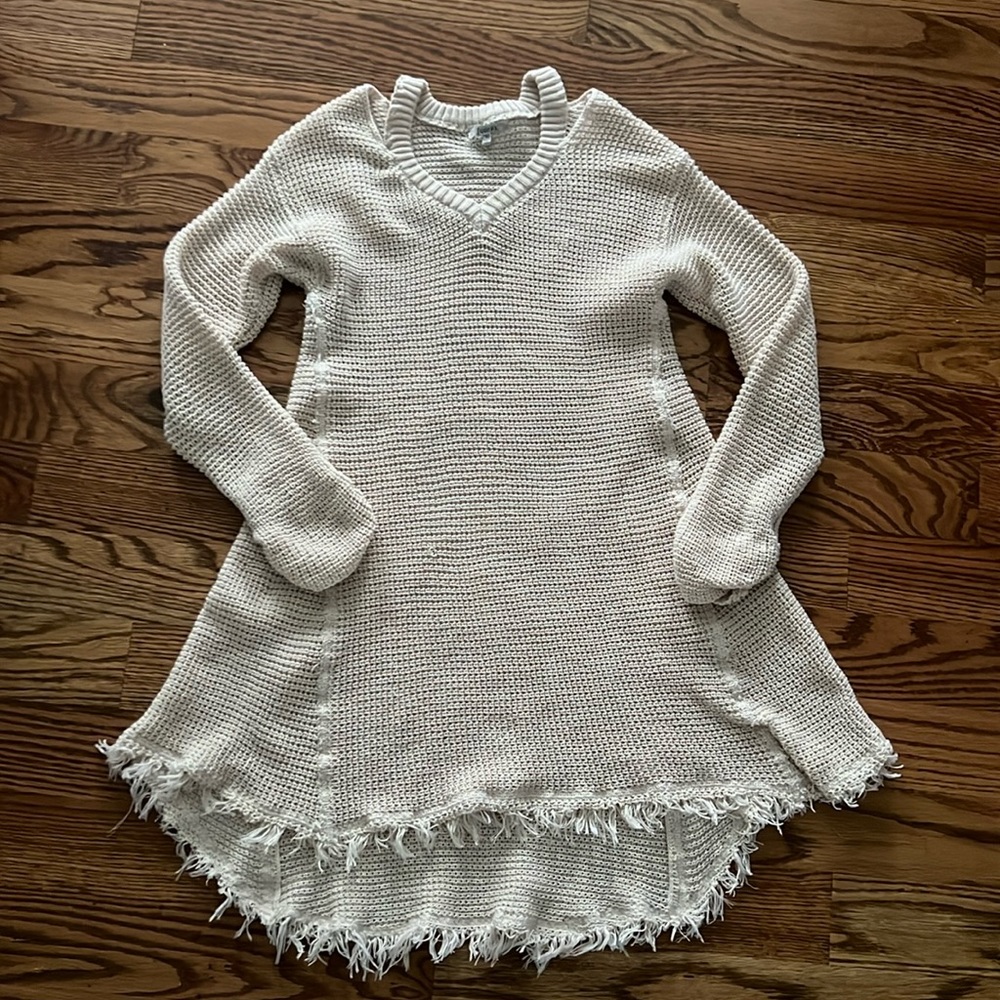 Beige woven tunic top with distressed hem.